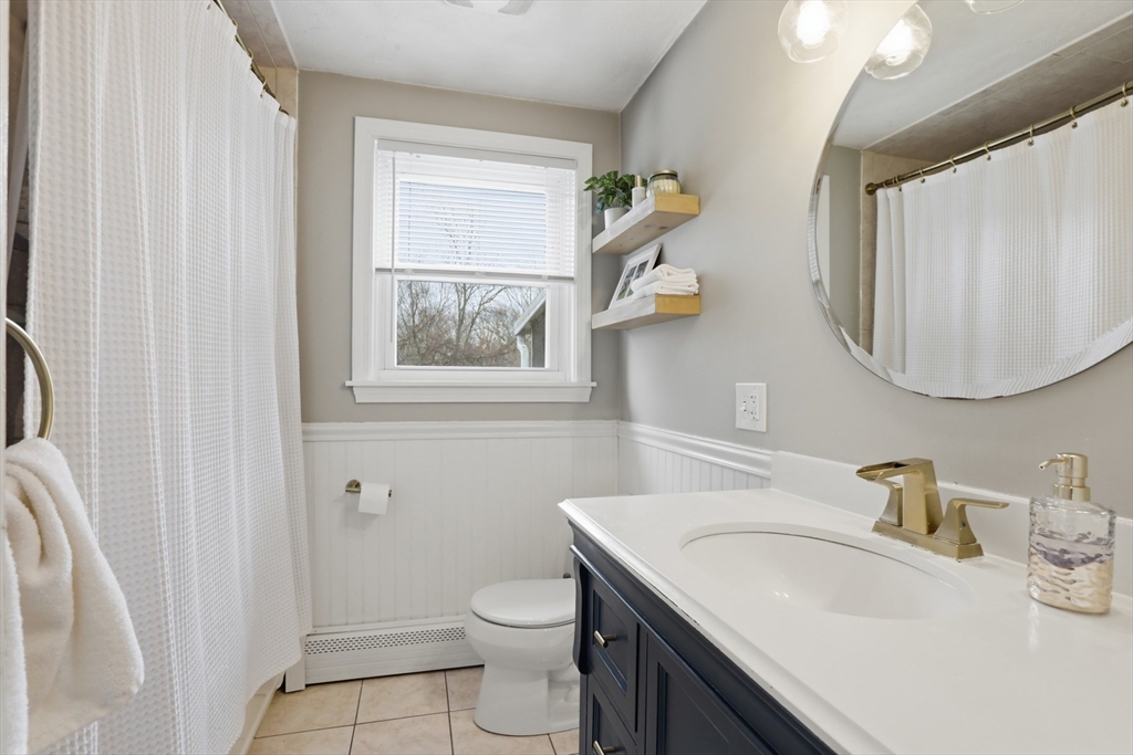 24 Clark Street Salem, MA 01970 - Photo 19 of 38 a bathroom with a granite countertop sink vanity mirror and toilet