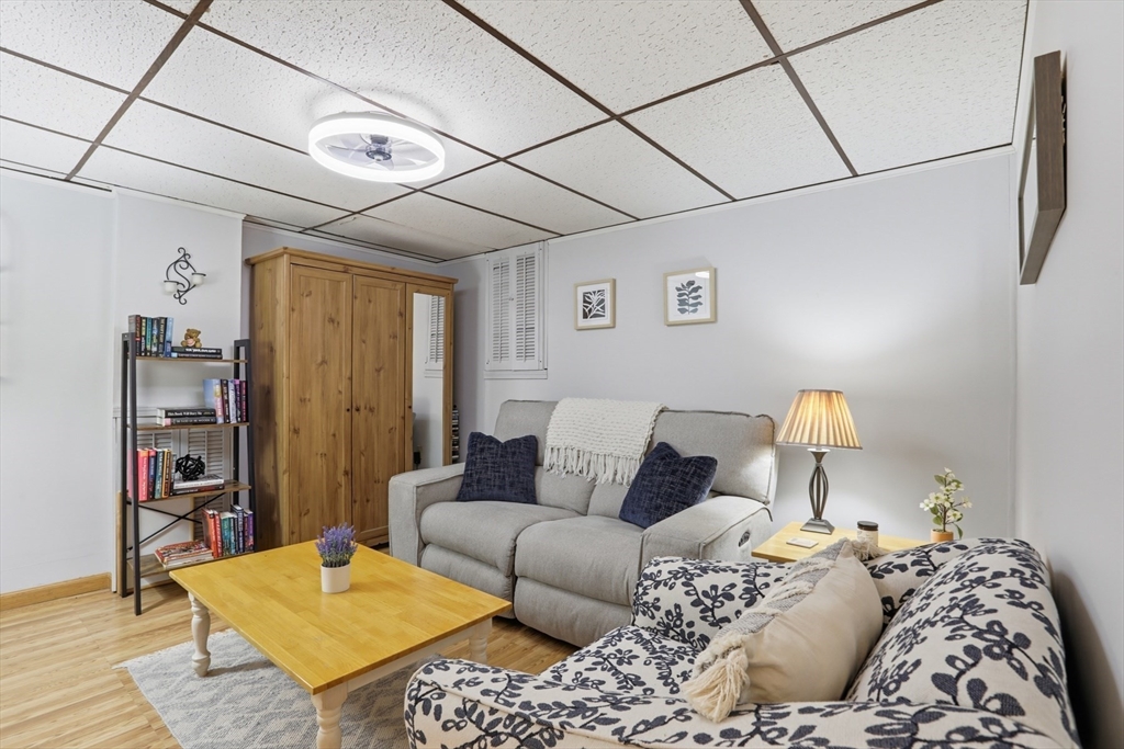 24 Clark Street Salem, MA 01970 - Photo 24 of 38 a bedroom with a bed a couch and a bookshelf