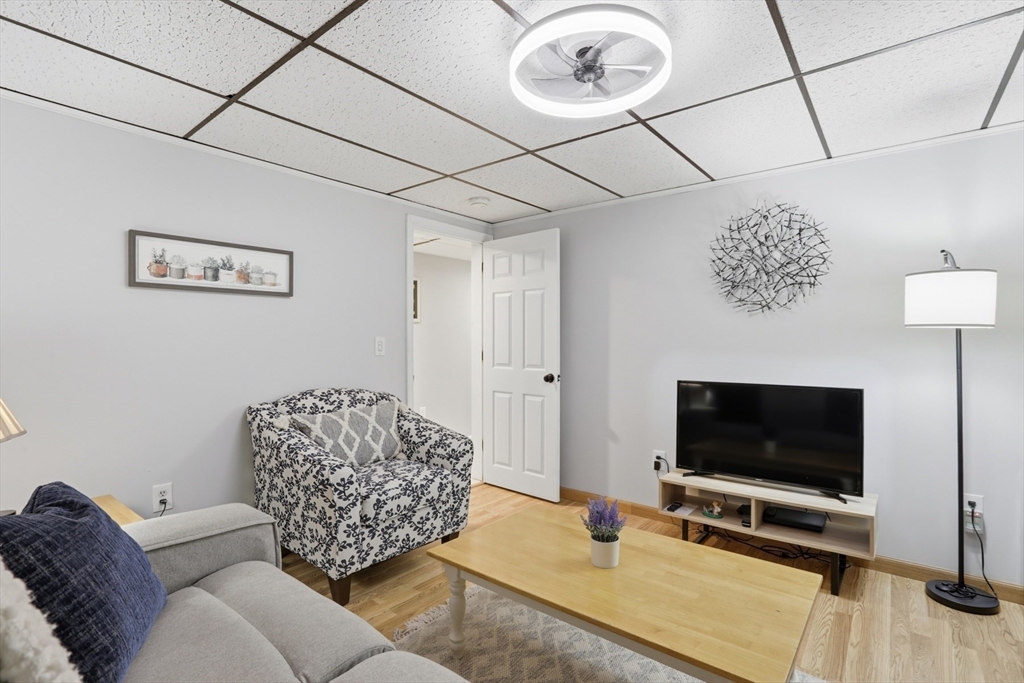 24 Clark Street Salem, MA 01970 - Photo 25 of 38 a living room with furniture and a flat screen tv