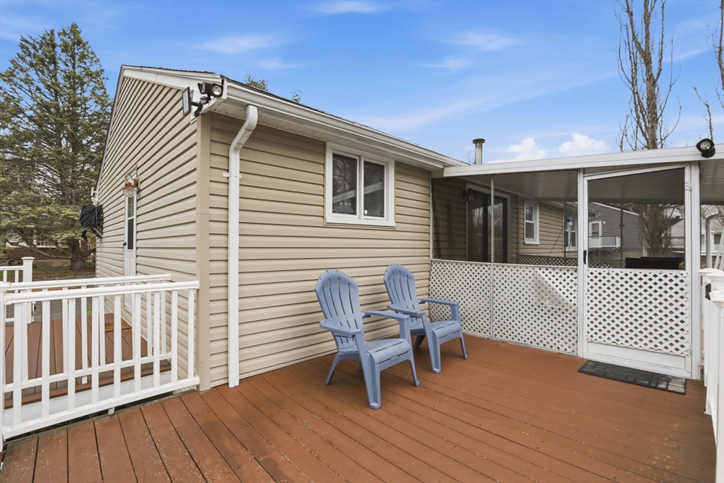 24 Clark Street Salem, MA 01970 - Photo 29 of 38 a view of a chair and table on the wooden deck