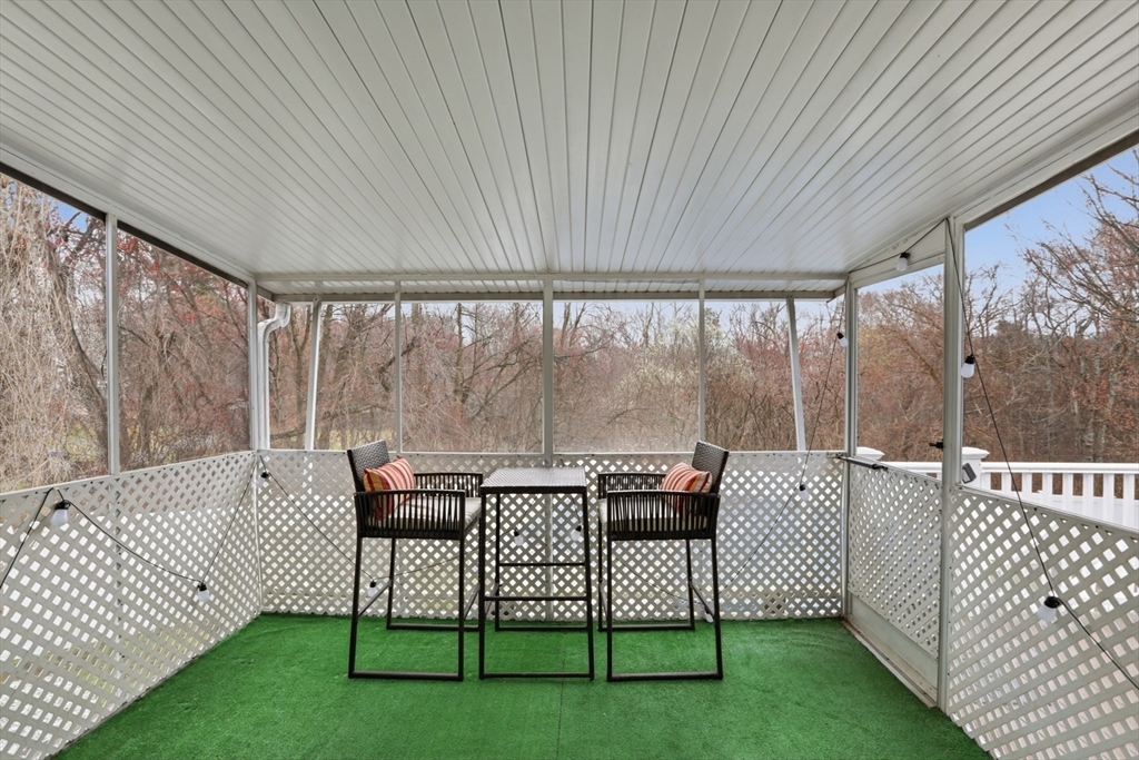 24 Clark Street Salem, MA 01970 - Photo 33 of 38 a roof deck with couches and wooden fence