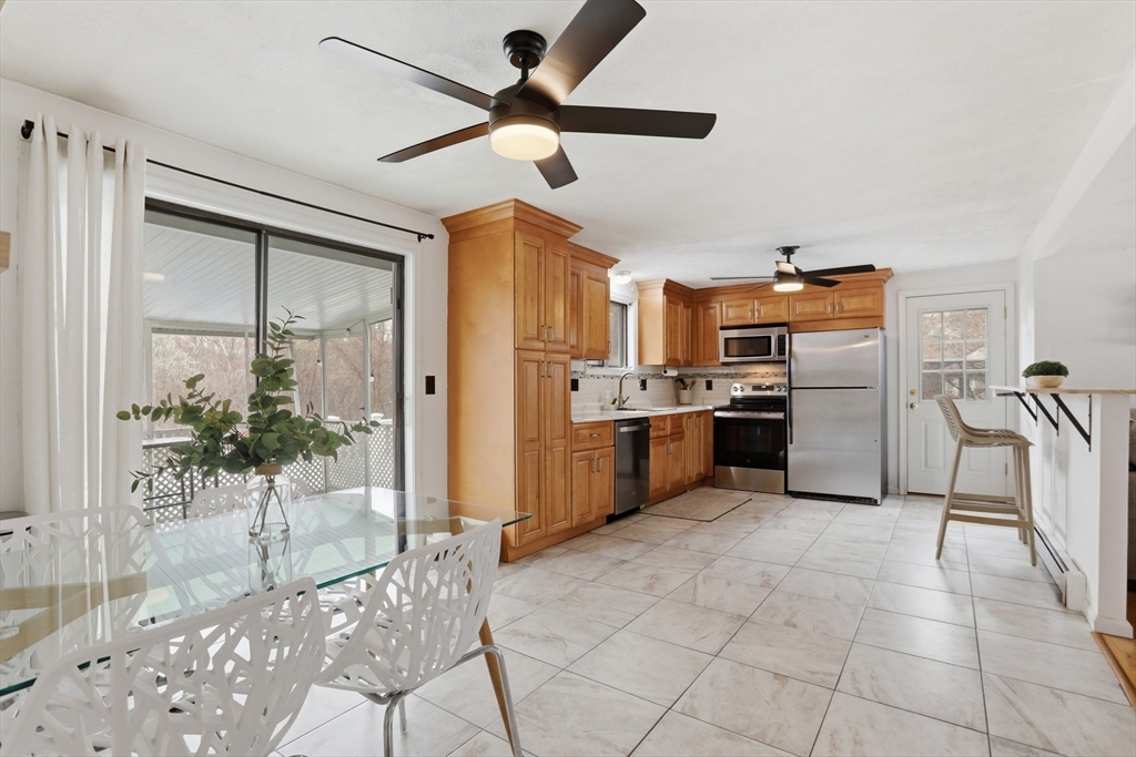 24 Clark Street Salem, MA 01970 - Photo 7 of 38 a kitchen with stainless steel appliances kitchen island granite countertop a refrigerator a stove and a sink