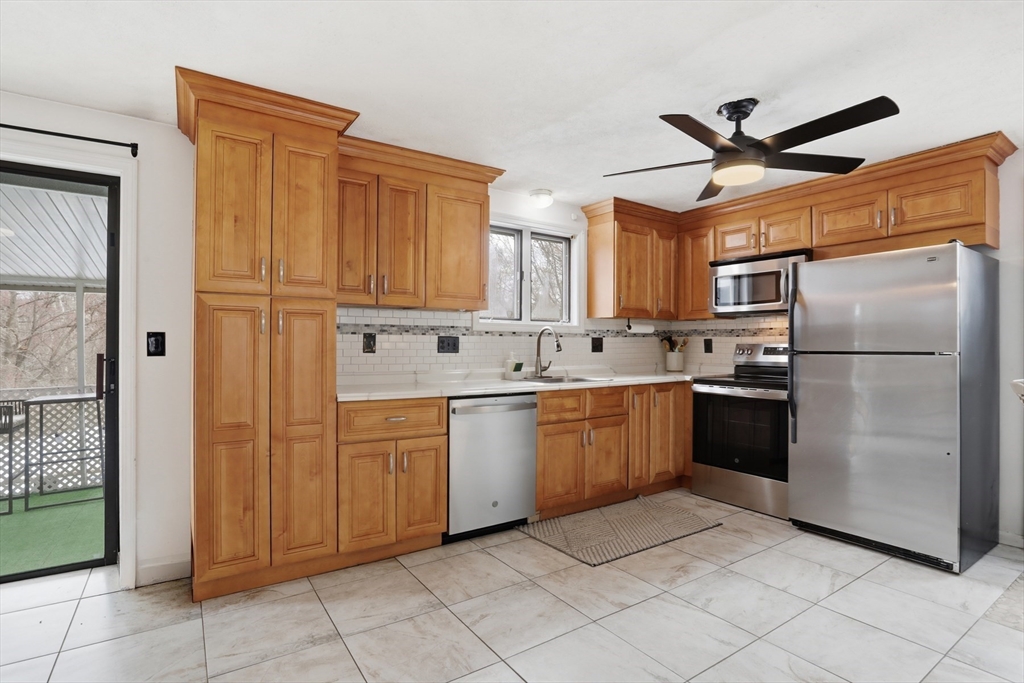 24 Clark Street Salem, MA 01970 - Photo 9 of 38 a kitchen with stainless steel appliances granite countertop a refrigerator and a sink