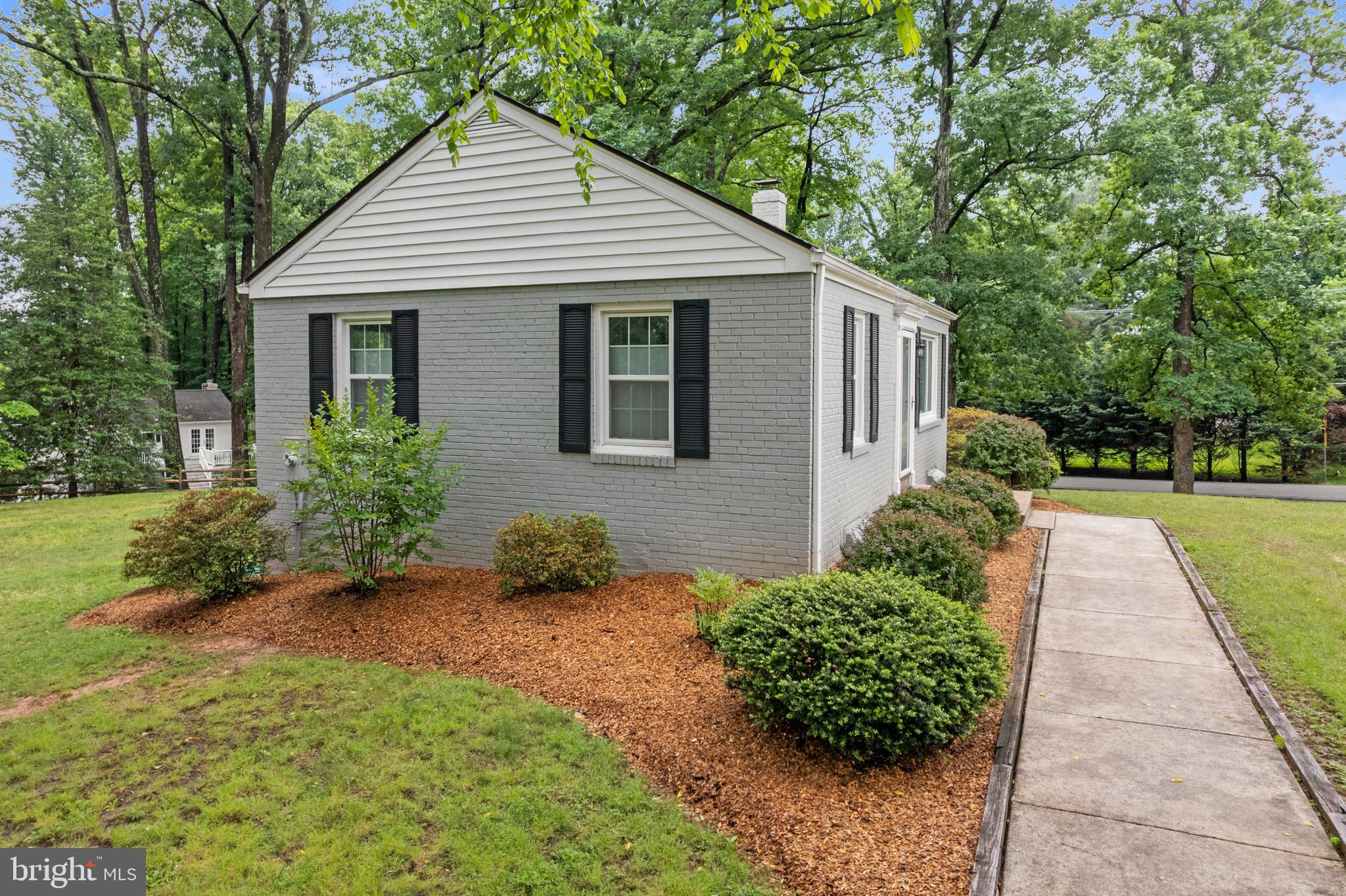 12131 Waples Mill Road Oakton, VA 22124 - Photo 24 of 40 a front view of a house with a yard and potted plants