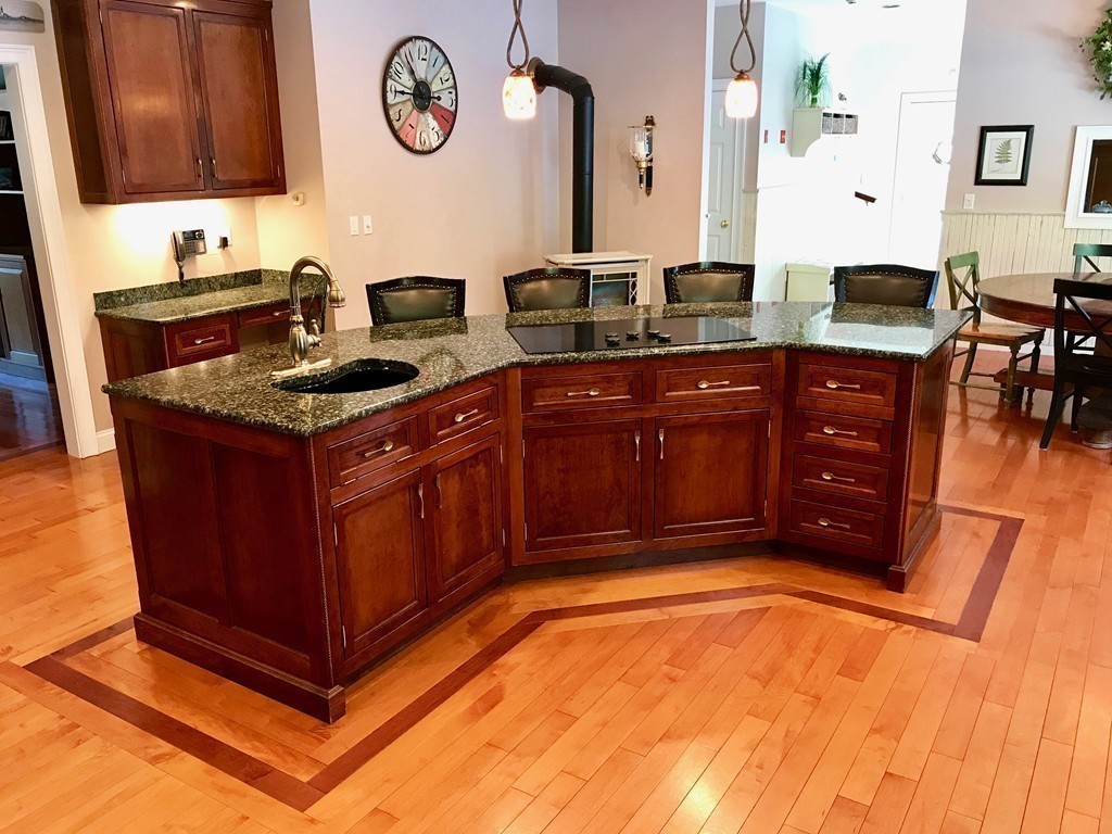 11 Kate's Lane Boxford, MA 01921 - Photo 15 of 30 a kitchen with stainless steel appliances granite countertop a stove a sink and a microwave