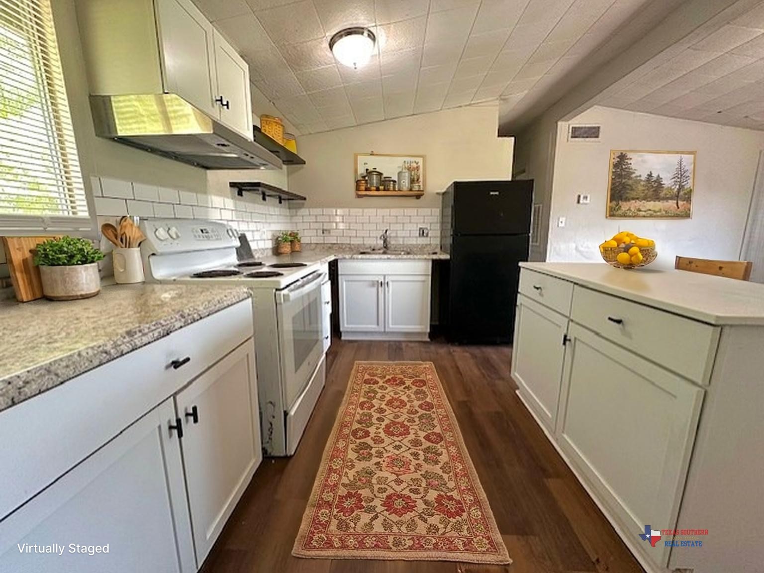 123 Stavena Road, Unit 3 Wharton, TX 77488 - Photo 3 of 9 a kitchen with granite countertop stainless steel appliances a stove a sink a refrigerator white cabinets and wooden floor