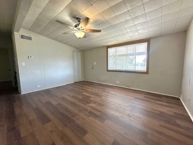 123 Stavena Road, Unit 3 Wharton, TX 77488 - Photo 4 of 9 an empty room with wooden floor fan and windows