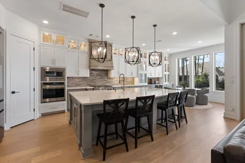 a large kitchen with a table and chairs