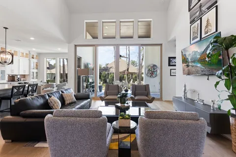 a living room with furniture fireplace and a large window