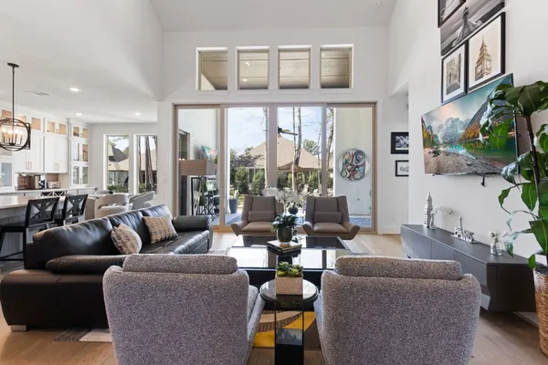 a living room with furniture fireplace and a large window