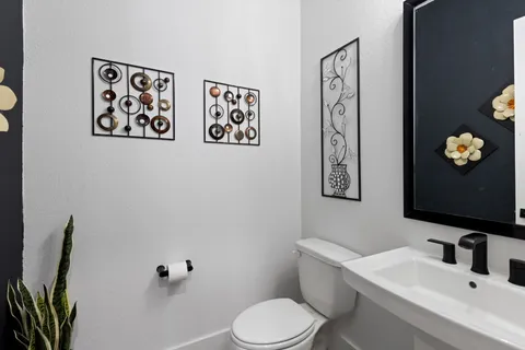 a bathroom with a toilet sink and mirror