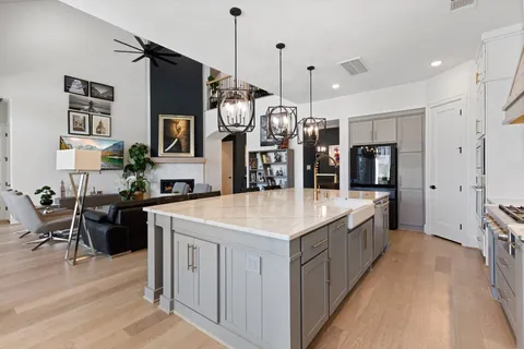 a large kitchen with stainless steel appliances kitchen island a large island in the center