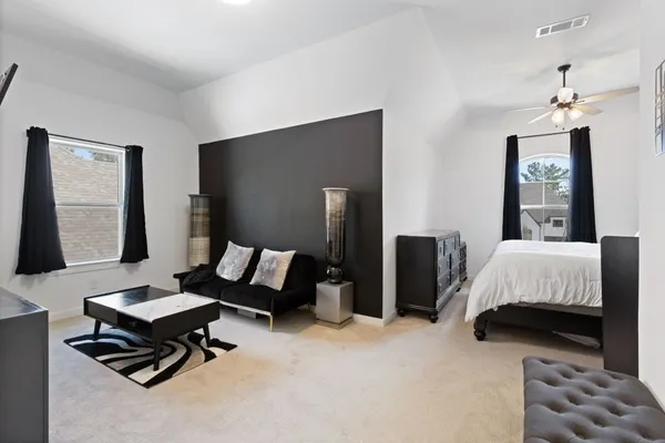 a bedroom with bed and window