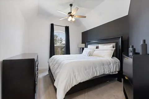 a bedroom with a bed and a chandelier