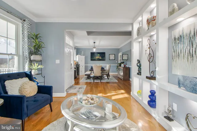 a open dining room with stainless steel appliances granite countertop a stove a refrigerator a sink dishwasher a dining table and chairs with wooden floor