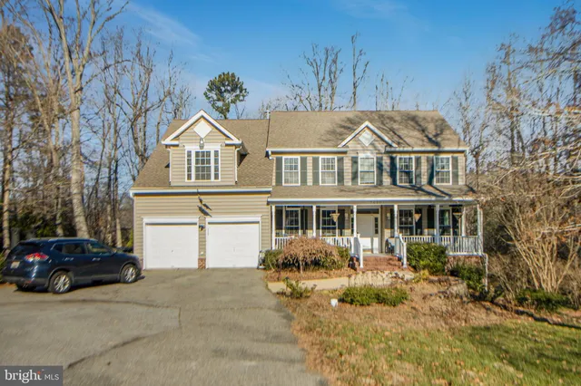 a living room with furniture a dining table and a chandelier