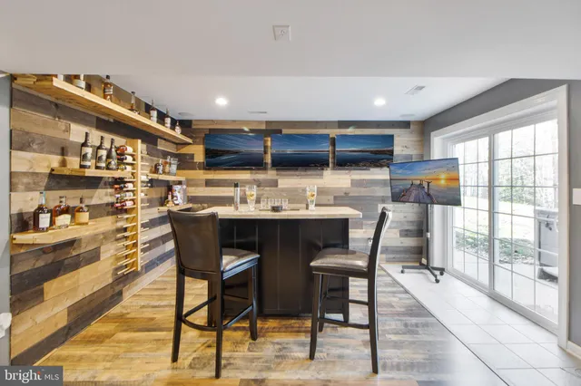 a spacious bedroom with a large bed and a chandelier