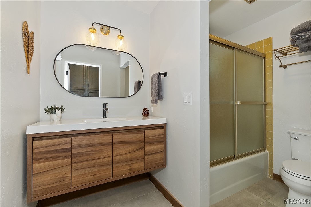 39343 Aurora Road Big Bear Lake, CA 92315 - Photo 22 of 50 a bathroom with a toilet sink and mirror