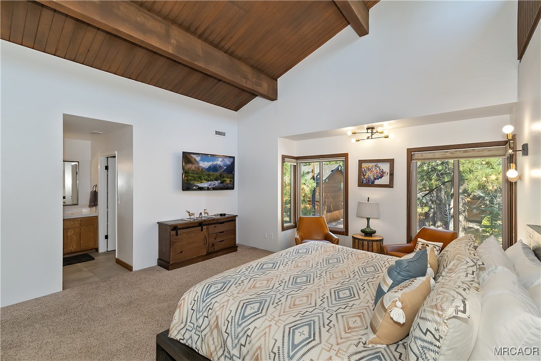 39343 Aurora Road Big Bear Lake, CA 92315 - Photo 25 of 50 a spacious bedroom with a bed and large windows