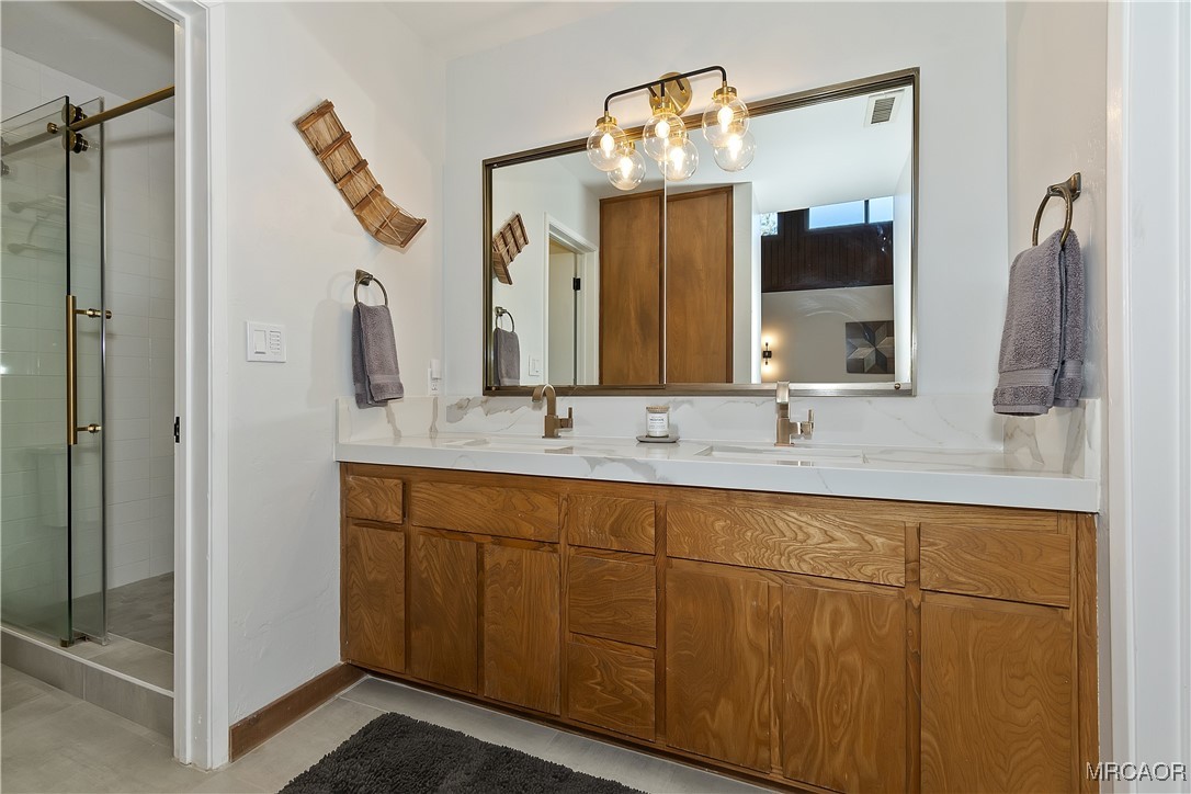 39343 Aurora Road Big Bear Lake, CA 92315 - Photo 26 of 50 a bathroom with a double vanity sink and a mirror