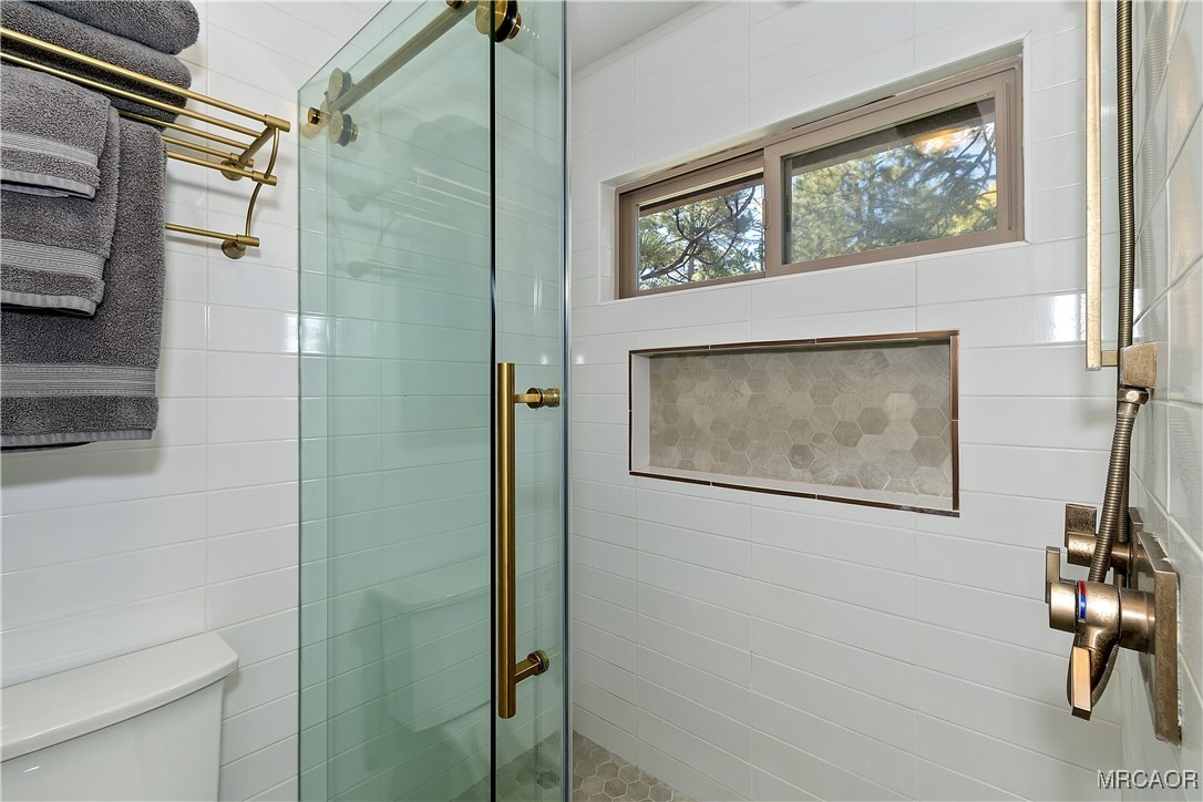 39343 Aurora Road Big Bear Lake, CA 92315 - Photo 27 of 50 a bathroom with a shower and a window