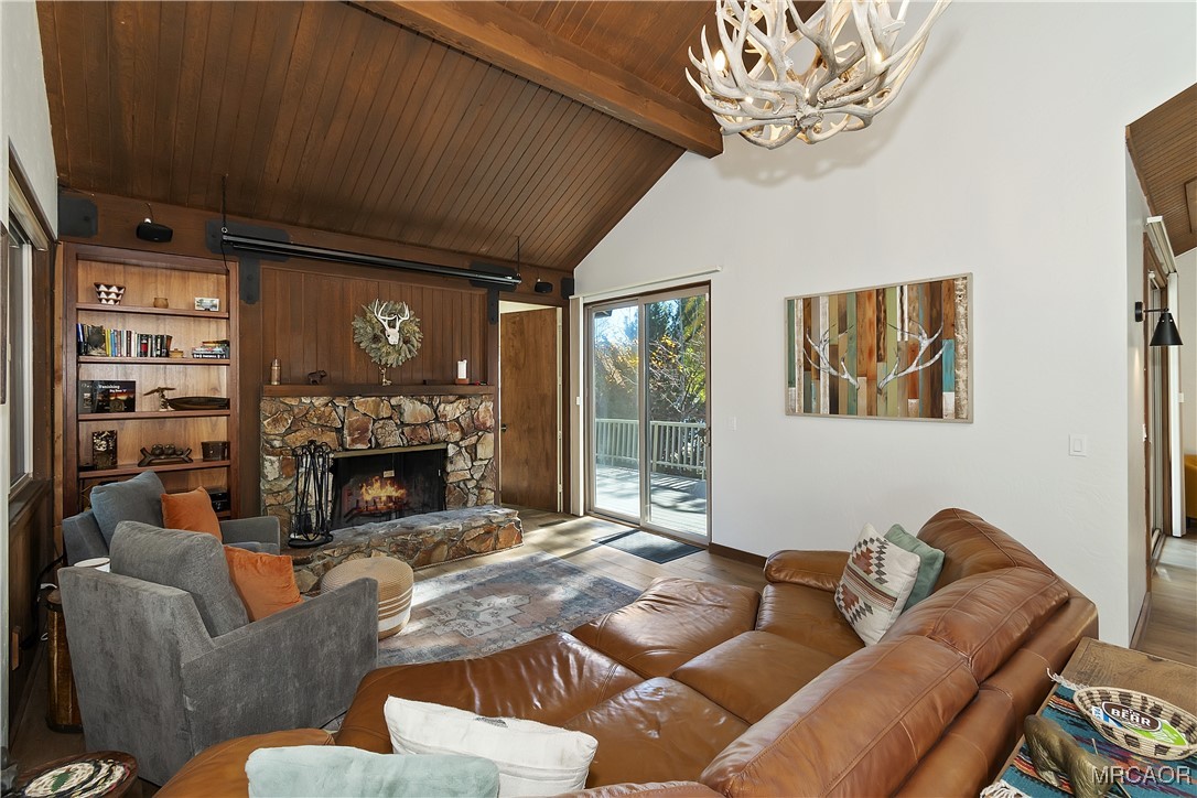 39343 Aurora Road Big Bear Lake, CA 92315 - Photo 8 of 50 a living room with furniture a chandelier and a fireplace