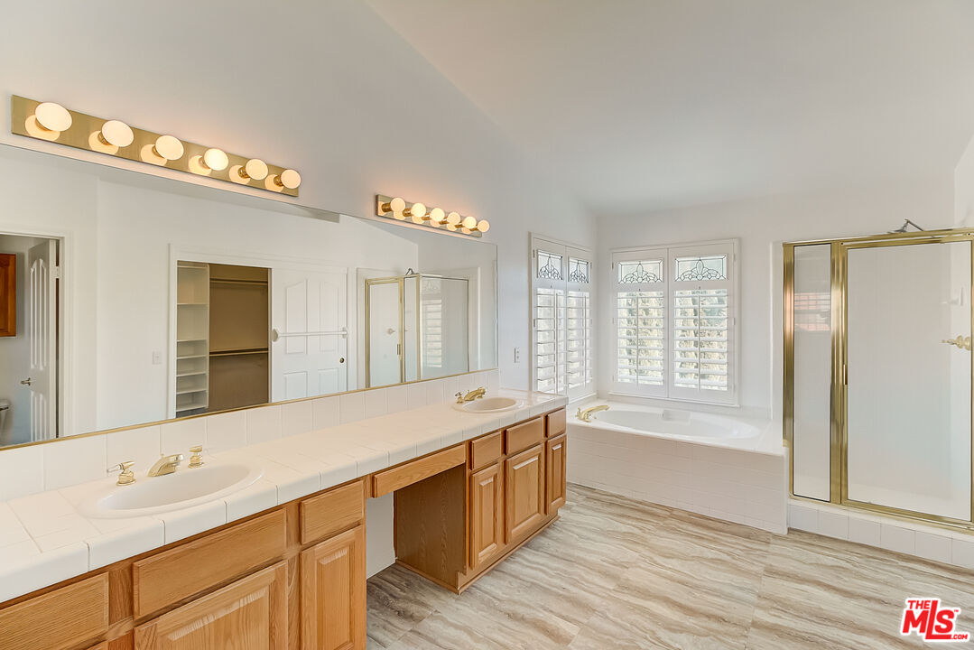 41908 Pico Way Palmdale, CA 93551 - Photo 6 of 35 a spacious bathroom with a tub double sink and mirror