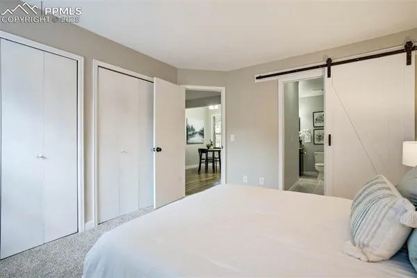 a bedroom with a bed and a mirror