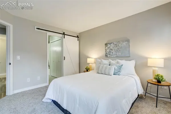 a bedroom with a bed and a night stand