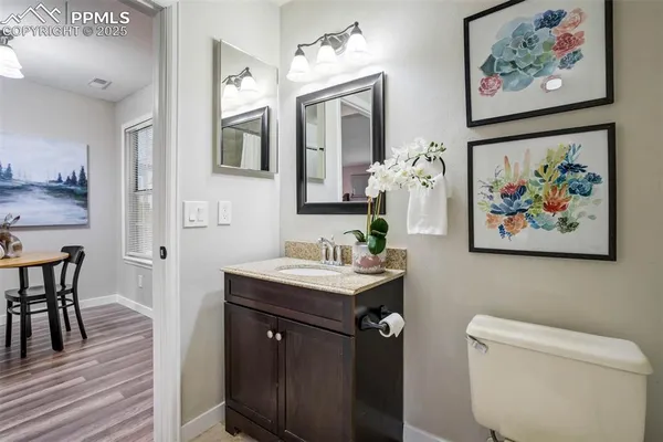 a bathroom with a painting on the wall and a sink