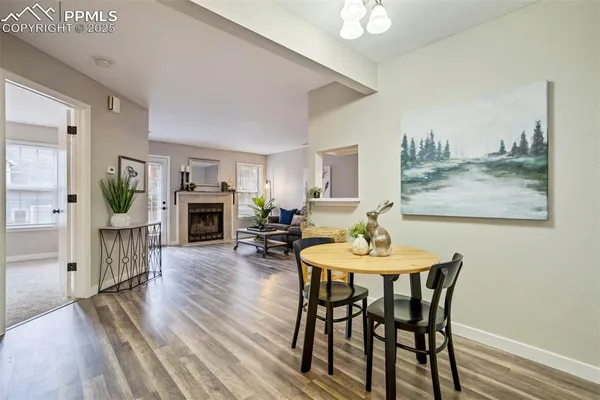 a view of a dining room with furniture and wooden floor