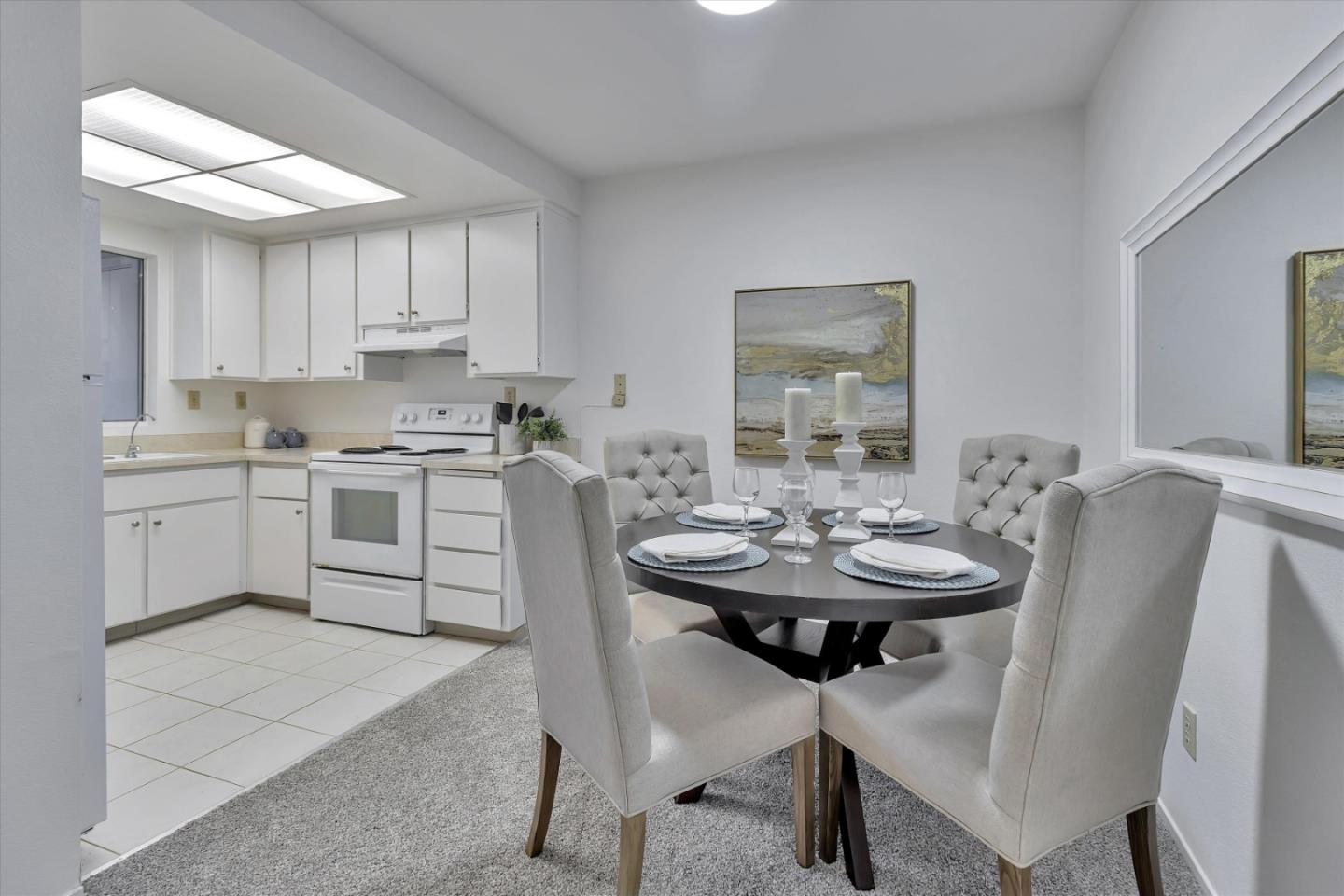 563 Shadow Dance Drive San Jose, CA 95110 - Photo 13 of 30 a kitchen with a sink stove and white cabinets with wooden floor