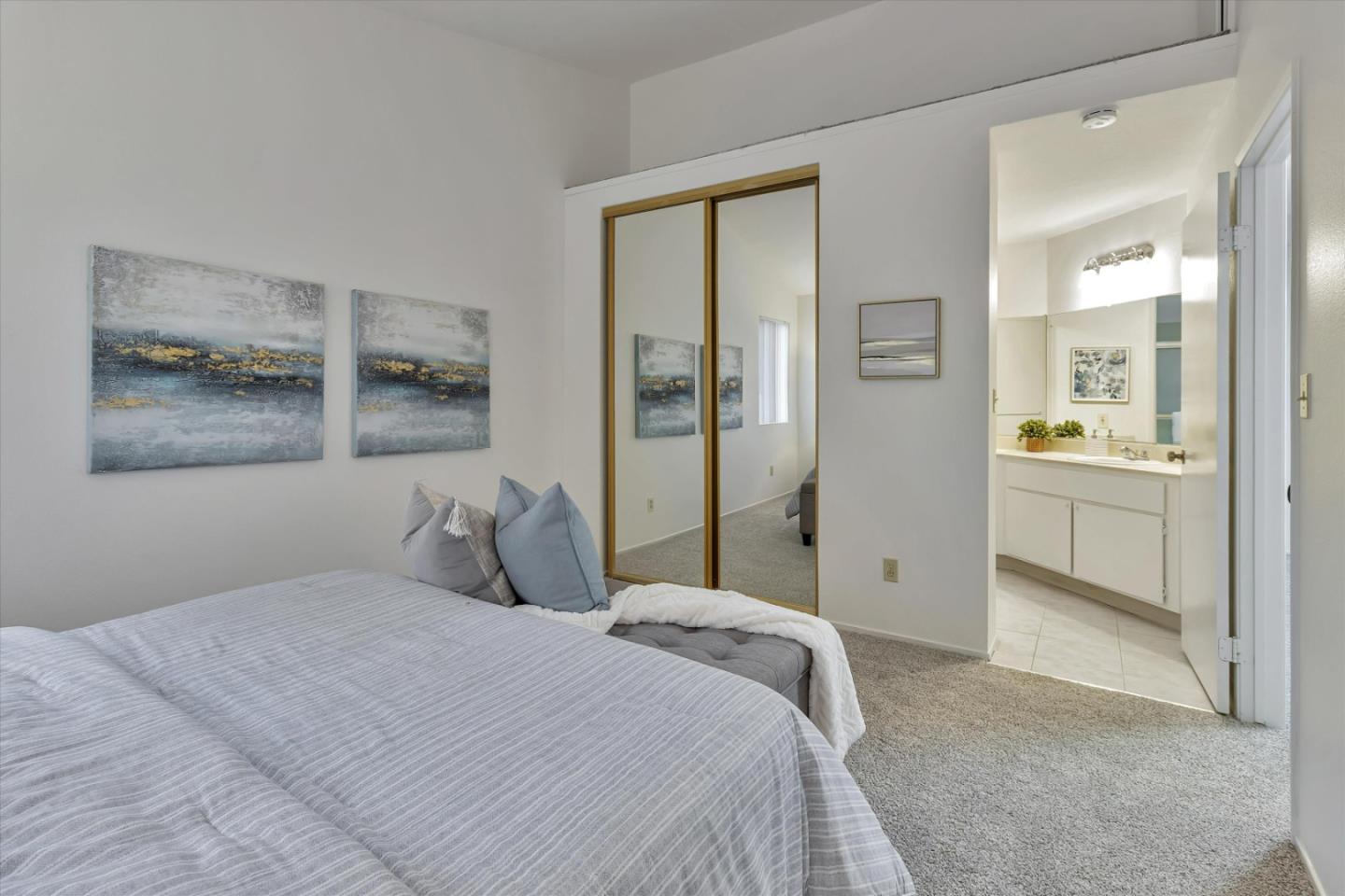 563 Shadow Dance Drive San Jose, CA 95110 - Photo 18 of 30 a bedroom with a large bed and a painting on the wall
