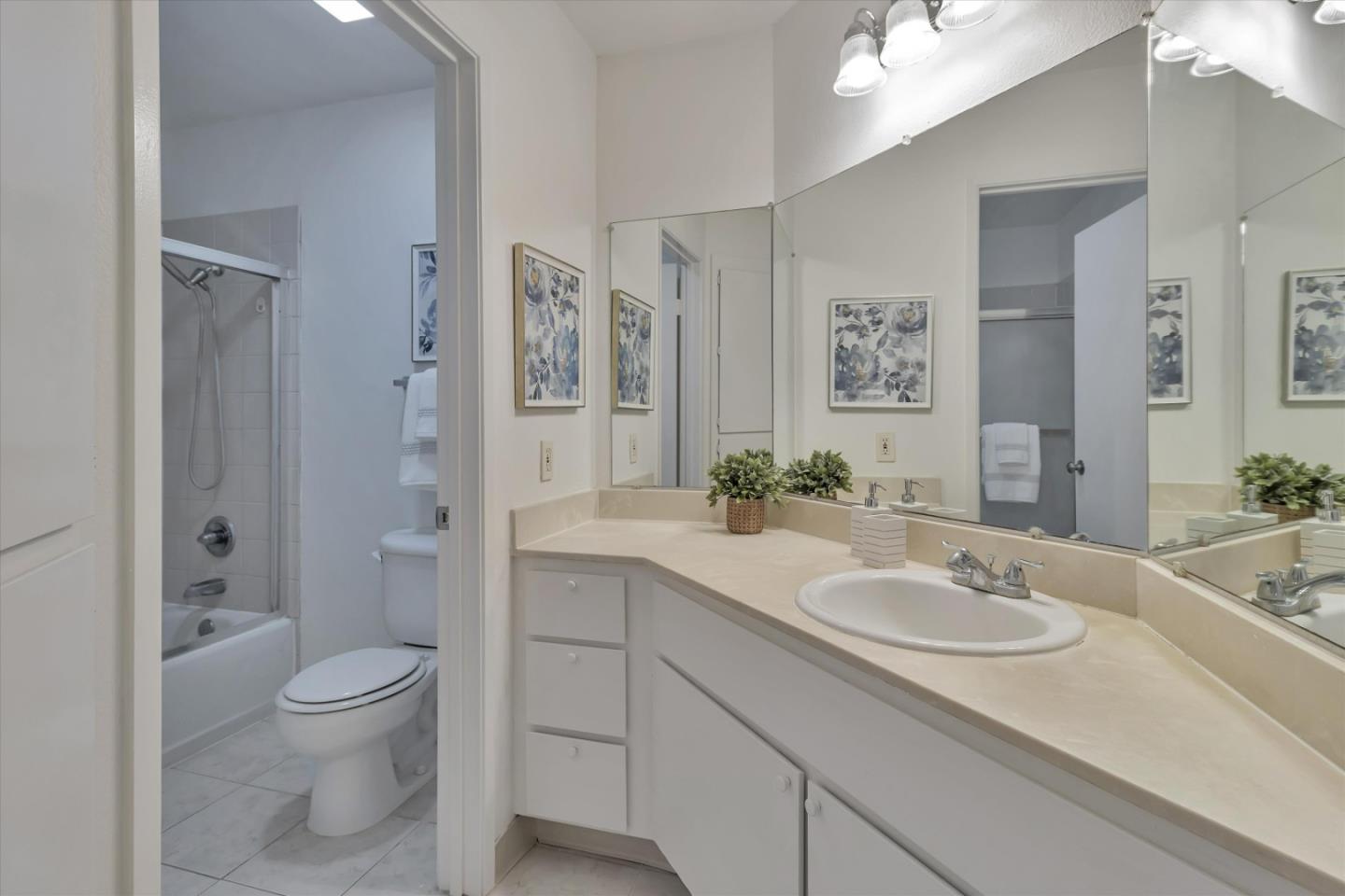 563 Shadow Dance Drive San Jose, CA 95110 - Photo 20 of 30 a bathroom with a granite countertop sink a toilet and shower