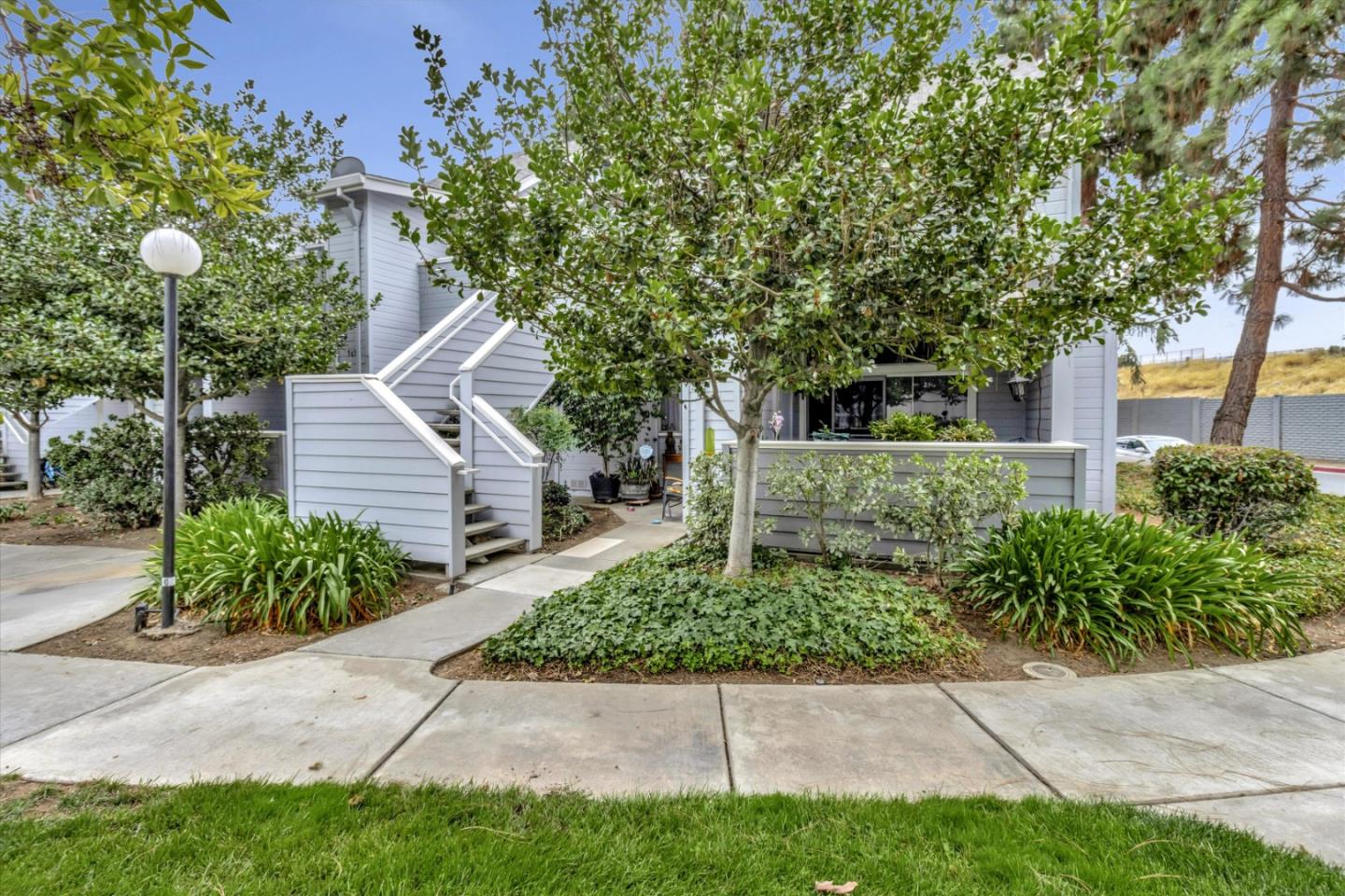 563 Shadow Dance Drive San Jose, CA 95110 - Photo 3 of 30 a front view of a house with a yard and fountain