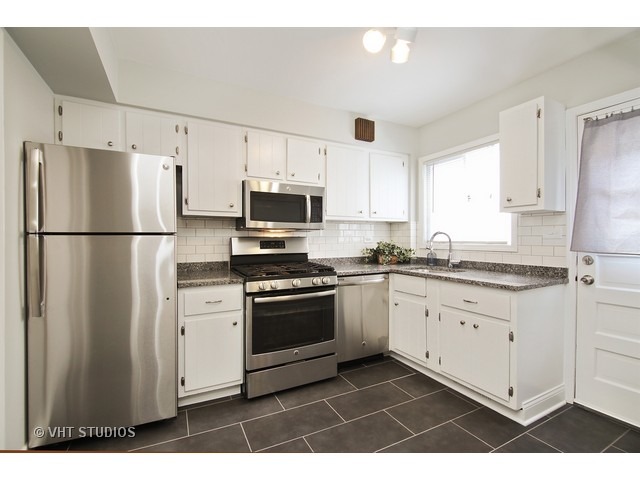 558 Green Bay Road Glencoe, IL 60022 - Photo 3 of 10 a kitchen with stainless steel appliances a refrigerator stove microwave and cabinets