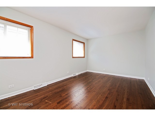 558 Green Bay Road Glencoe, IL 60022 - Photo 6 of 10 an empty room with wooden floor and windows