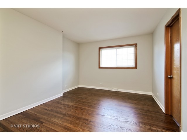 558 Green Bay Road Glencoe, IL 60022 - Photo 7 of 10 an empty room with wooden floor and windows