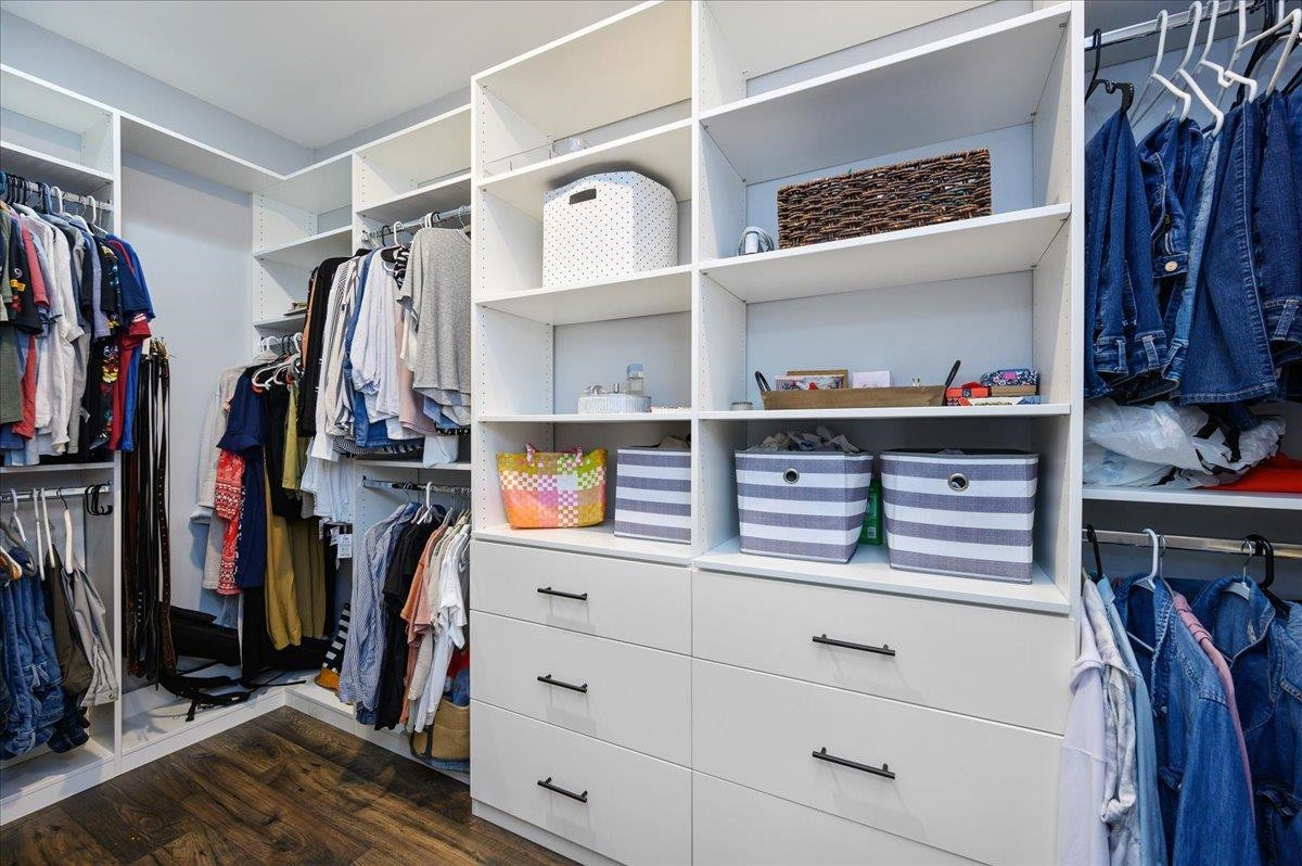 7032 Rex Road Holly Springs, NC 27540 - Photo 19 of 38 An amazing closet system in the primary bedroom maximizes the use of space. Custom closet in primary bedroom