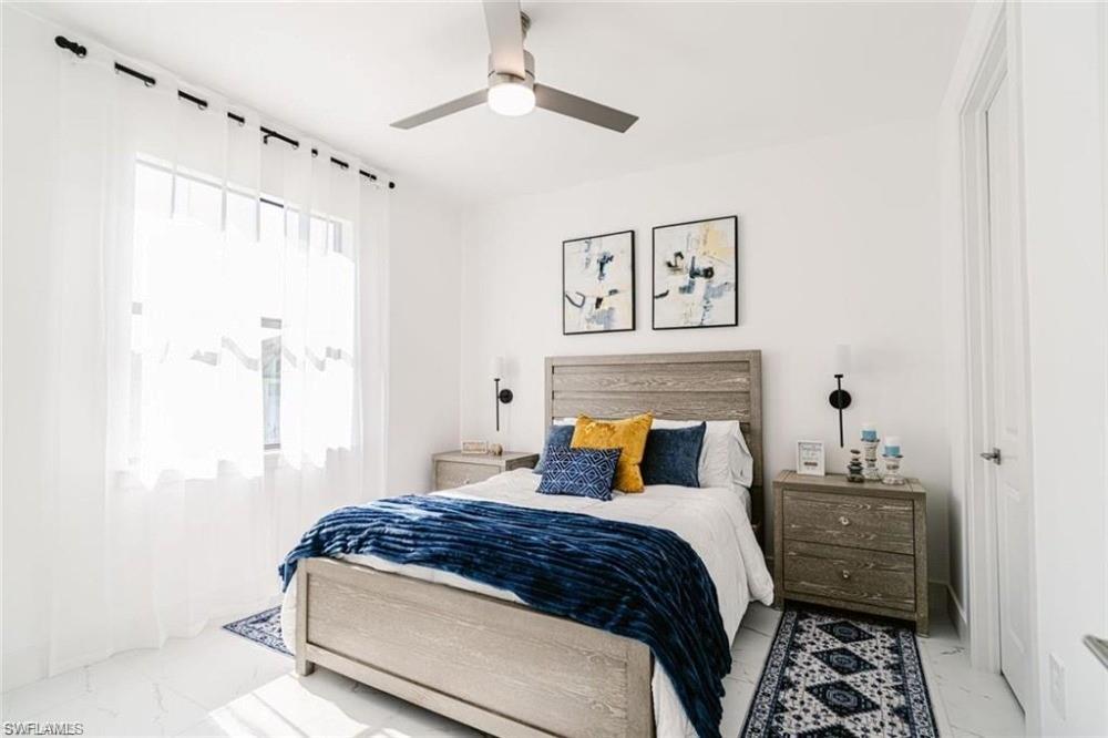 951 Graystone Avenue Lehigh Acres, FL 33974 - Photo 2 of 8 a bedroom with a bed and a window