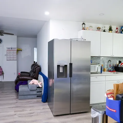 a kitchen with a refrigerator and a stove