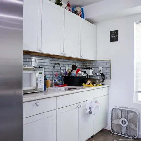 a bathroom with a shower and a sink