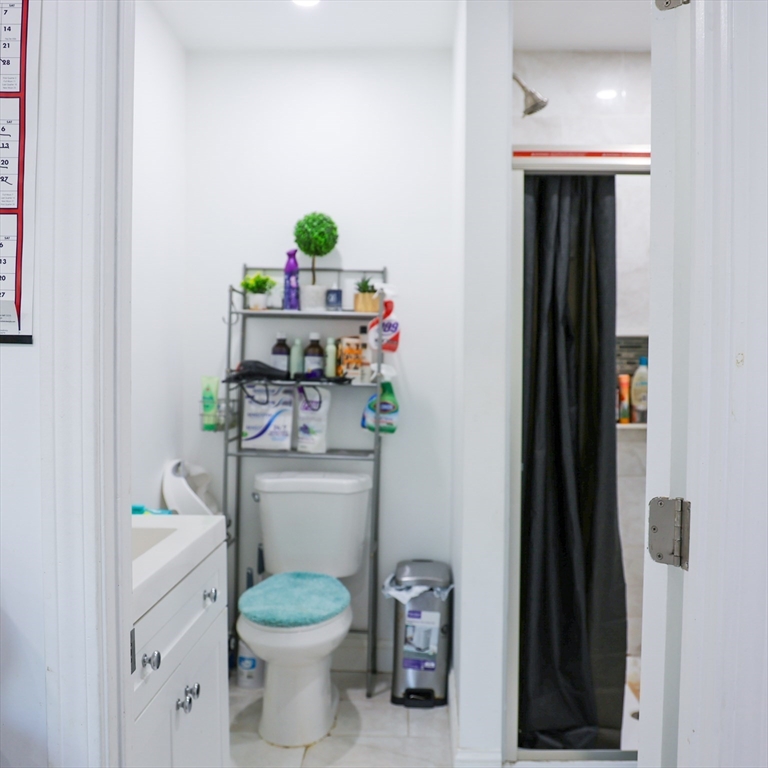 84 Cambridge Street Lowell, MA 01851 - Photo 15 of 42 a bathroom with a toilet a sink and vanity