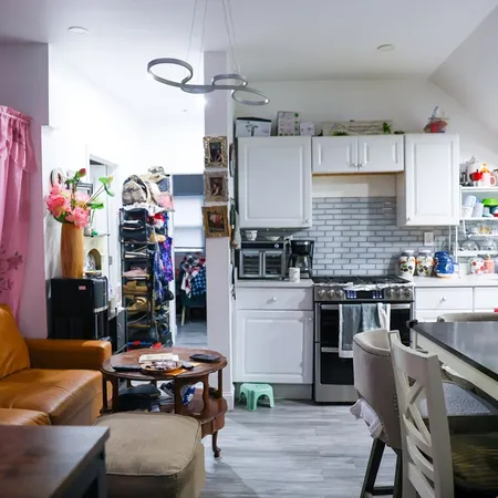 a kitchen with stainless steel appliances a sink stove and cabinets