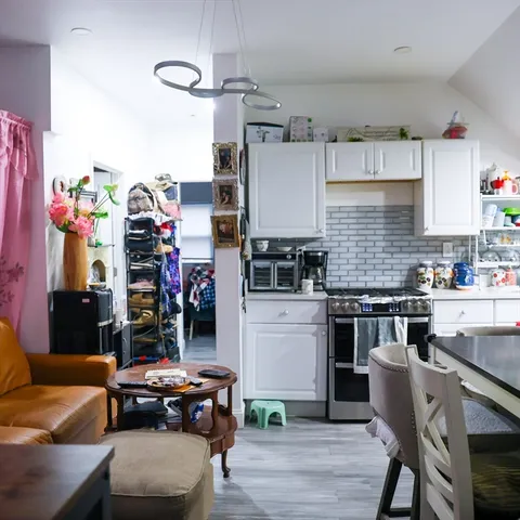 a kitchen with stainless steel appliances a sink stove and cabinets