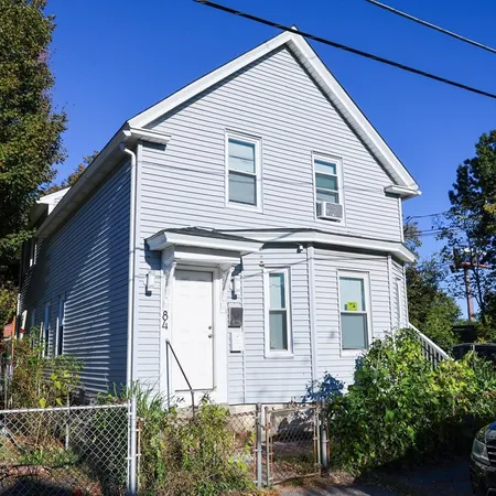 a view of house with a yard and potted plants
