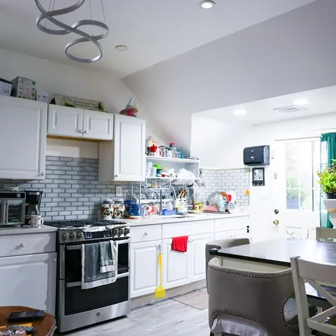 a kitchen with a stove and a wooden cabinets