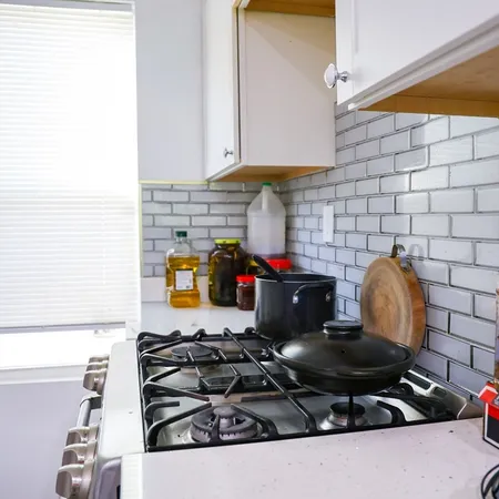 a kitchen with stainless steel appliances granite countertop a stove and a cabinets