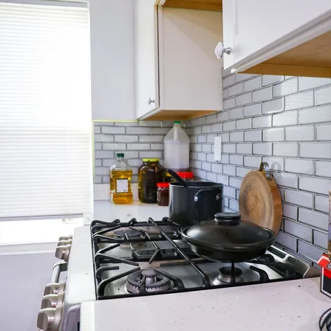 a kitchen with stainless steel appliances granite countertop a stove and a cabinets