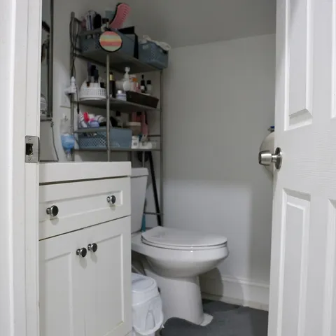 a bathroom with a toilet and a shower curtain